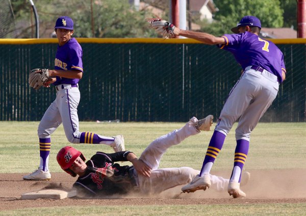 Lemoore's Anfernee Murrieta tags out Hanford's Clay
Gillum in a double play attempt Tuesday in a 5-4 loss to the Bullpups.